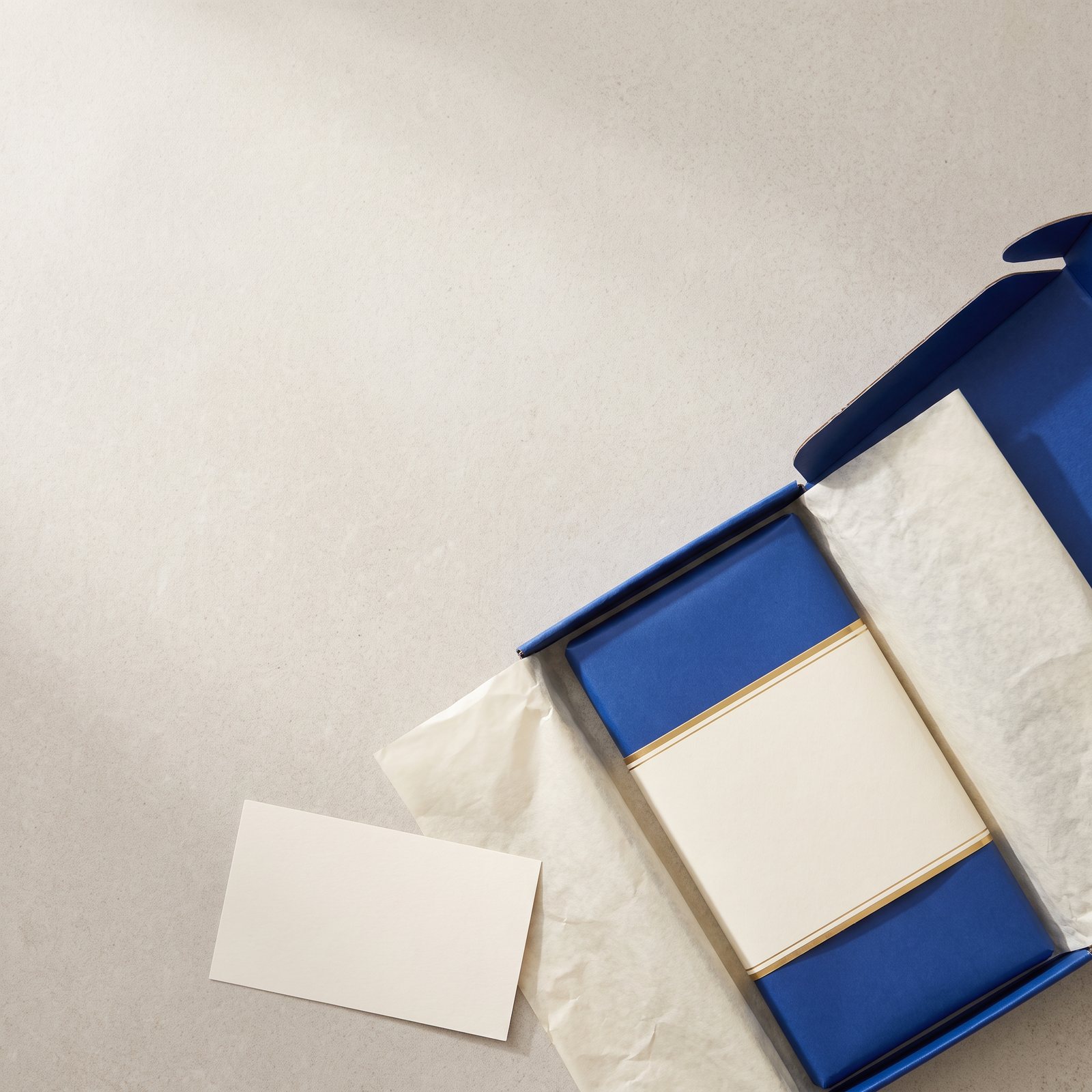 An open blue mailer with the sleeved chocolate bar and a handwritten-style card